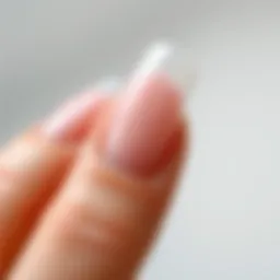 Close-up of a beautifully manicured nail with an artificial nail extension.